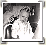 Angel Delgadillo giving a haircut to an unhappy little boy in the 1950s